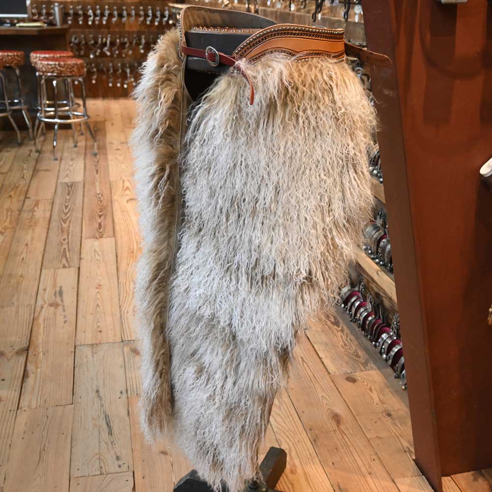 Why do cowboys wear chaps on their legs?